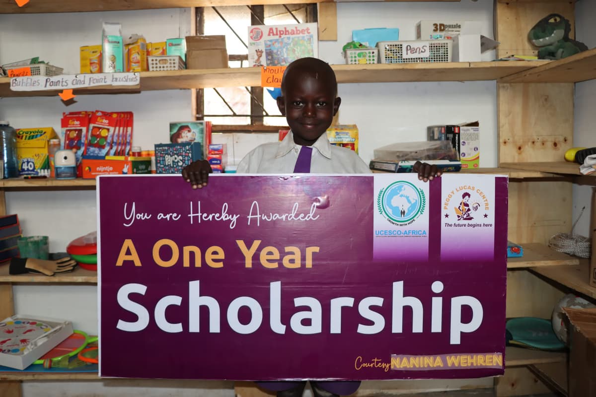 Happy boy with sponsorship cheque