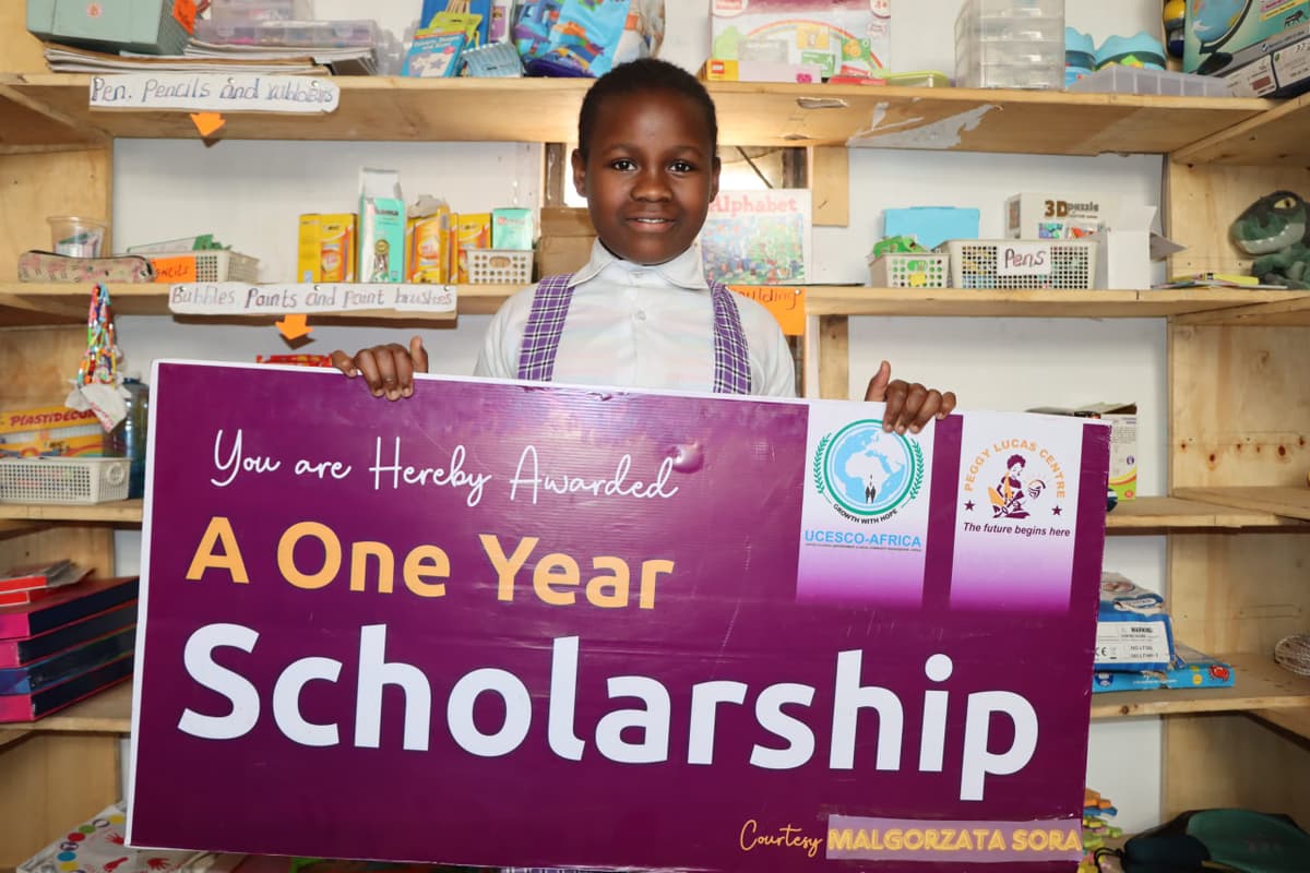 Happy girl with sponsorship cheque