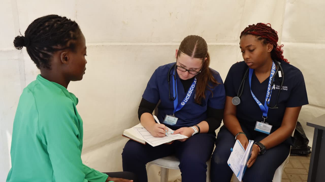 Doctor taking patient data at medical camp